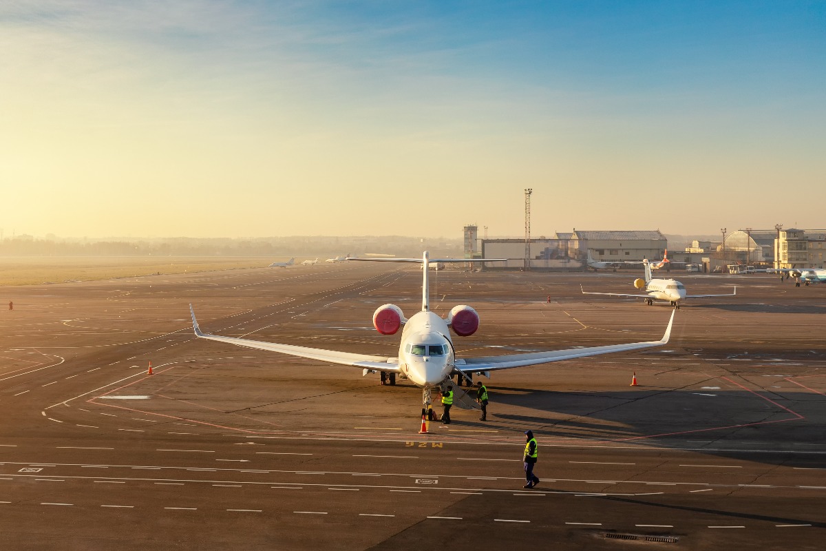 Colorful scenic dramatic morning sunset at airport asphalt taxiway and parking with different commercial passenger airplanes and private jets ready dor departure flight tickets booking and charter jpg