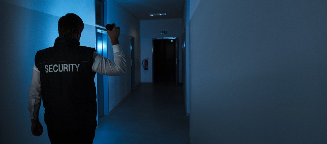 Security Guard Standing In Corridor Of The Building